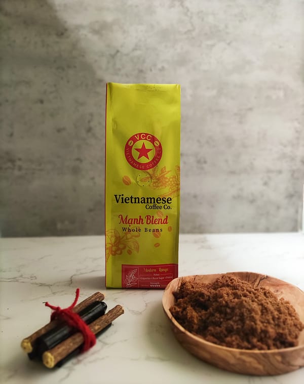 A bag of Moi blend Vietnamese coffee. Pictured with a bundle of liquorice sticks and a dish of brown sugar.