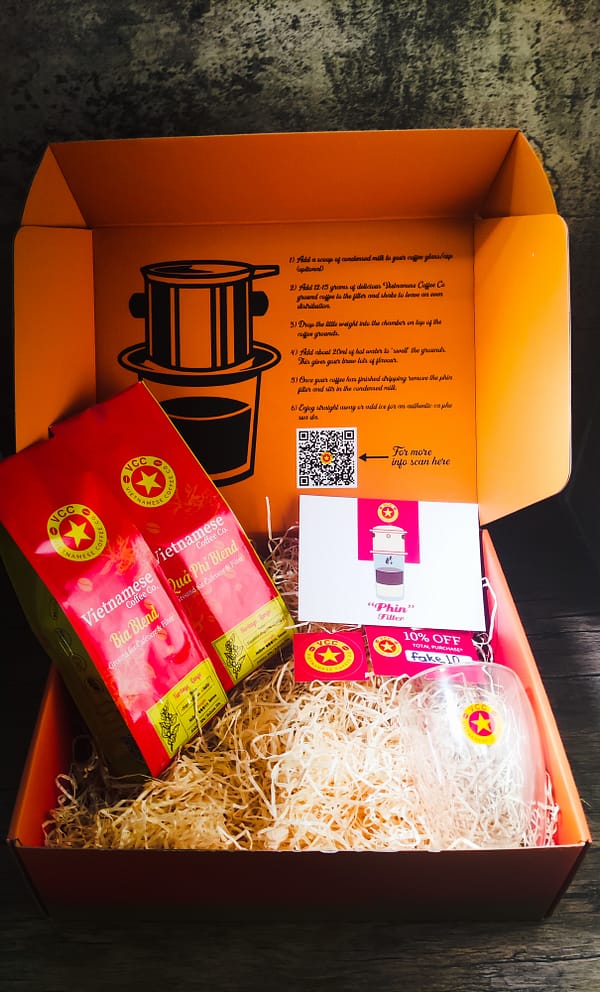 Vietnamese coffee gift box. Two varieties of Vietnamese Coffee from a branded double wall coffee glass., a discount voucher, stickers and a postcard.