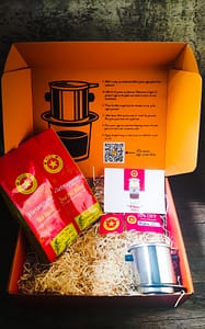 Vietnamese coffee gift box. Two varieties of Vietnamese Coffee from our Heritage range, a Phin filter., a discount voucher, stickers and a postcard.