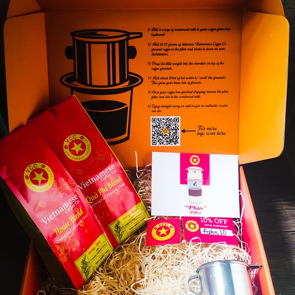 Vietnamese coffee gift box. Two varieties of Vietnamese Coffee from our Heritage range, a Phin filter., a discount voucher, stickers and a postcard.